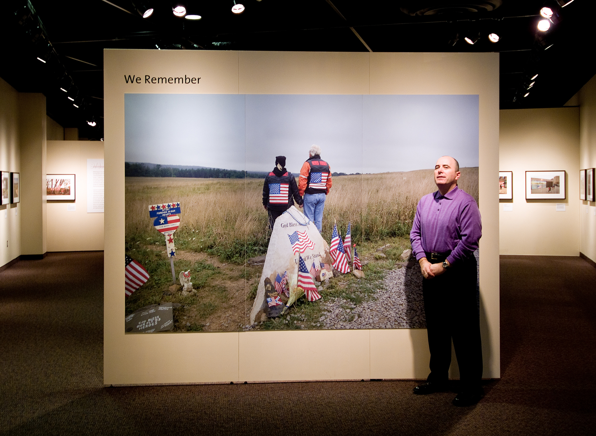 Jonathan C. Hyman standing beside his mural-scale photograph 'We Remember' at the National Constitution Center