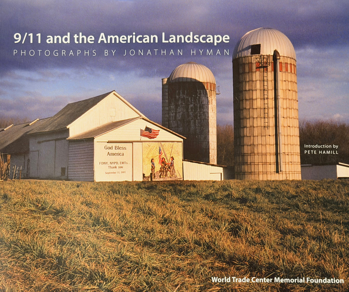 Cover of the World Trade Center Memorial Foundation exhibition catalogue featuring a rural barn mural honoring 9/11 first responders