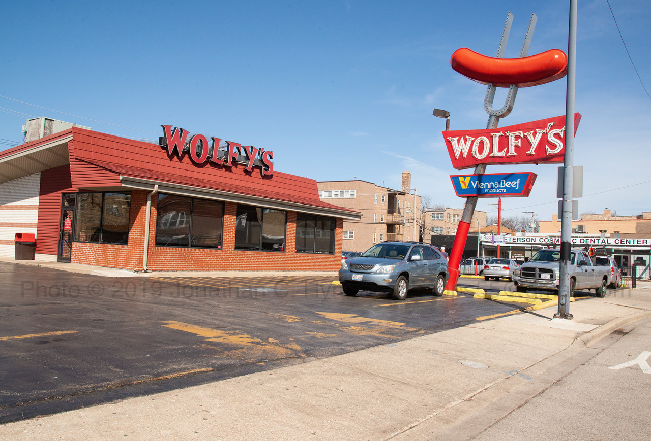 Wolfy's hot dog stand in Chicago with its towering neon hot dog and fork sign