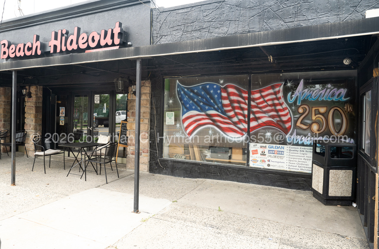 Beach Hideout storefront in Brooklyn, New York with a painted American flag and America 250 mural